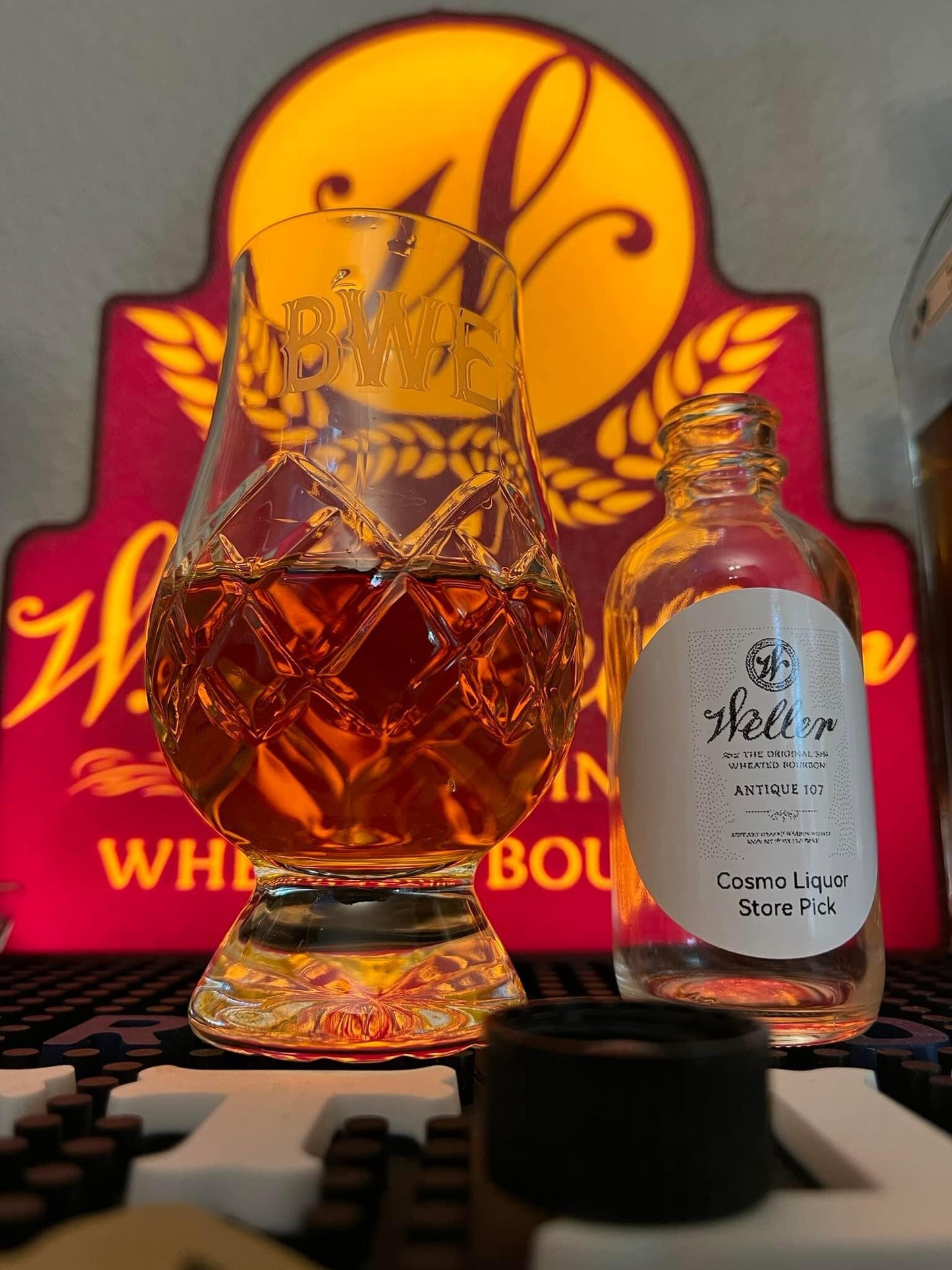 a bottle of booze next to a glass of booze