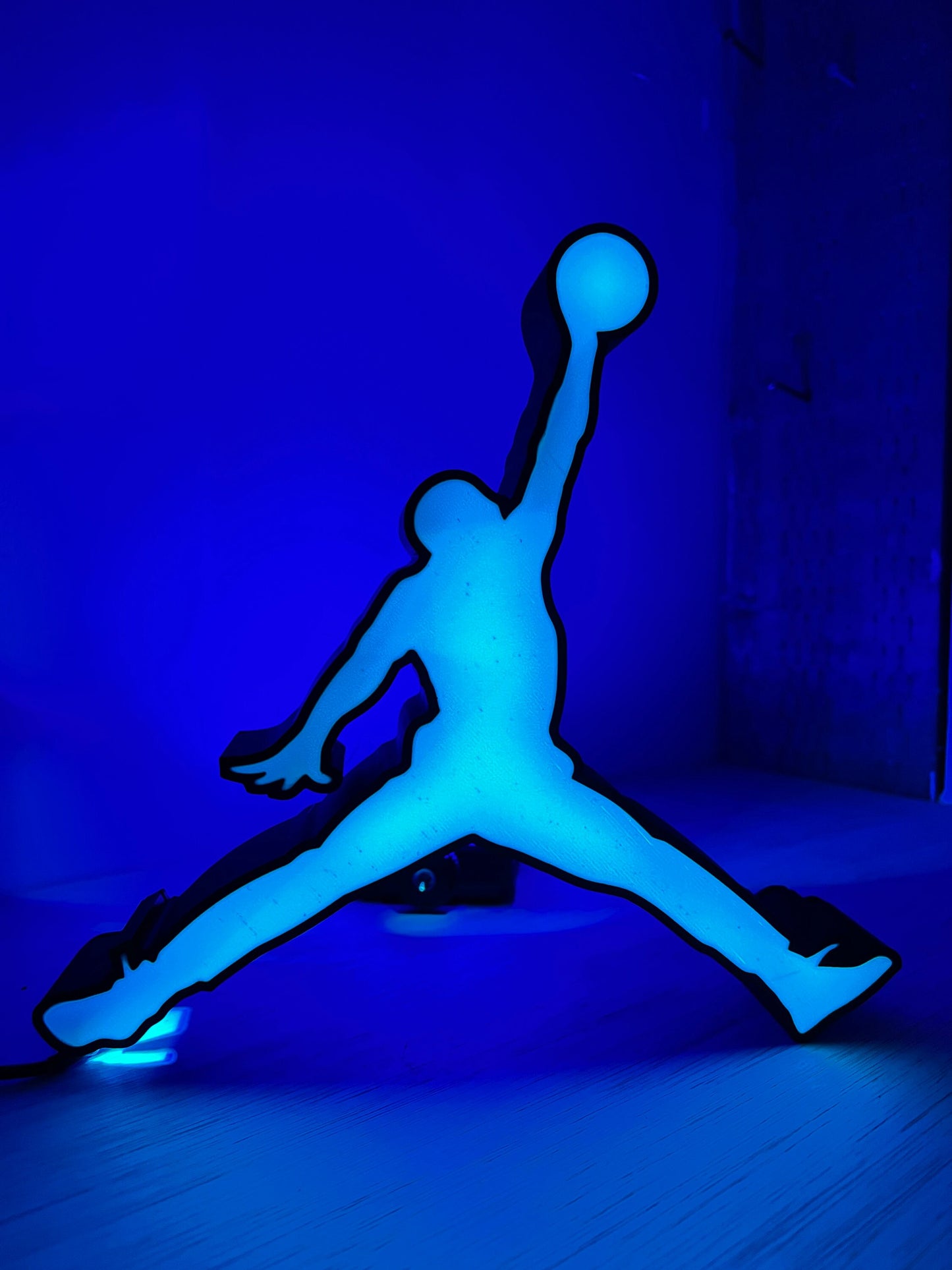 a neon blue picture of a person jumping in the air