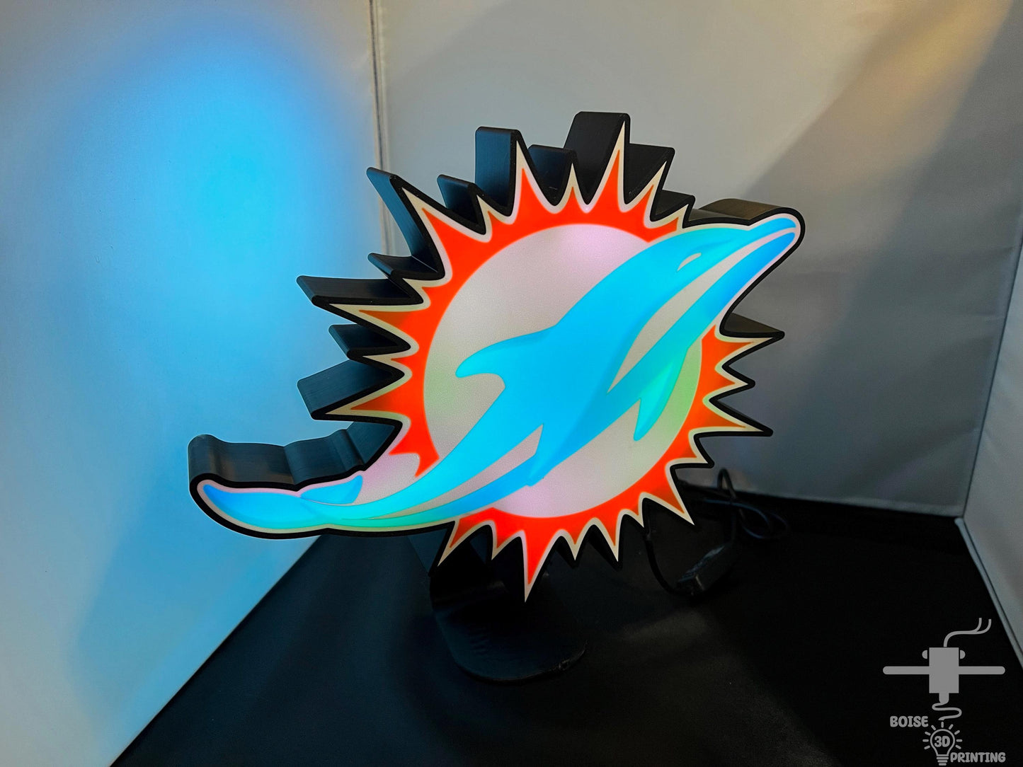 a paper sculpture of a sun and a dolphin's mouth