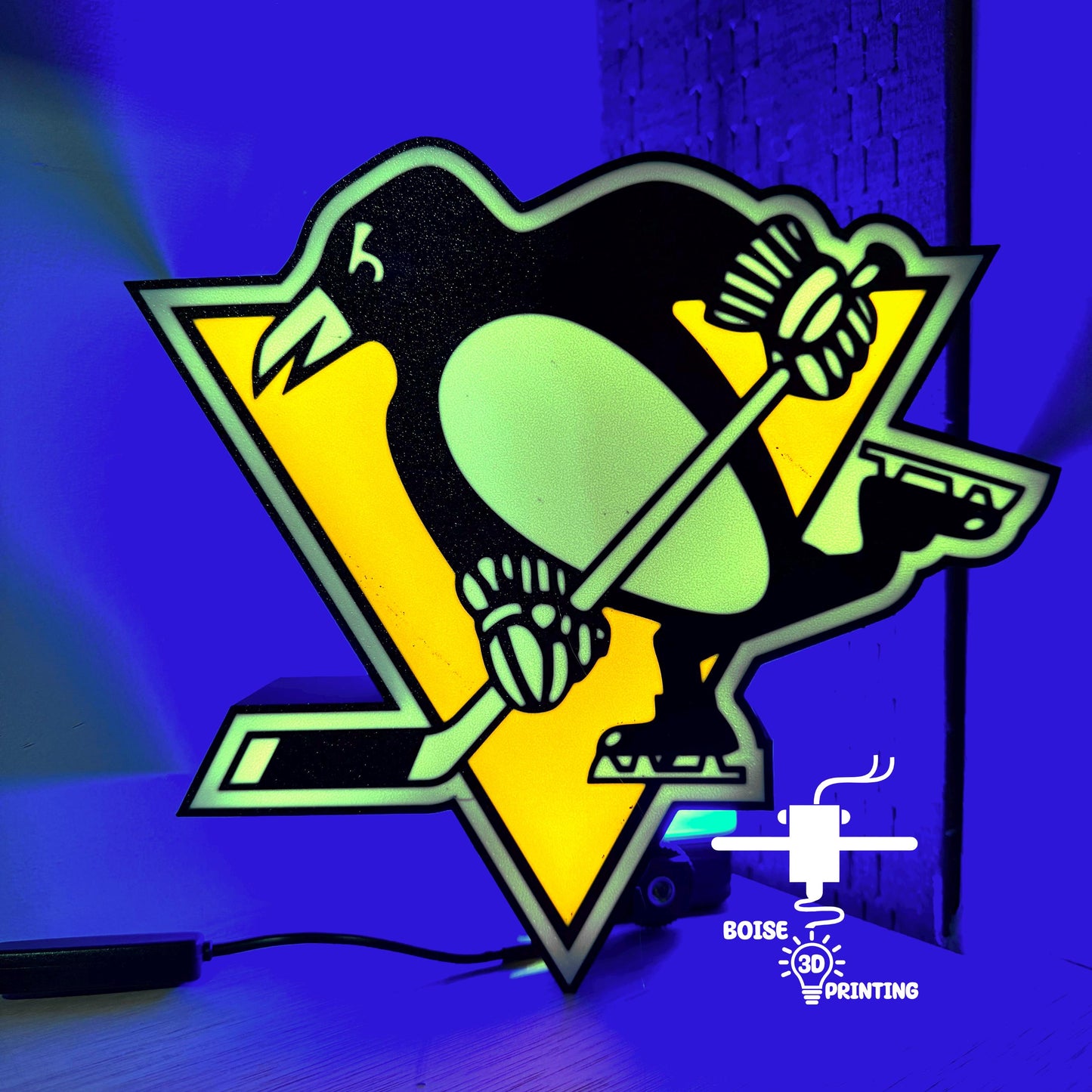 a picture of a hockey logo with a penguin on it