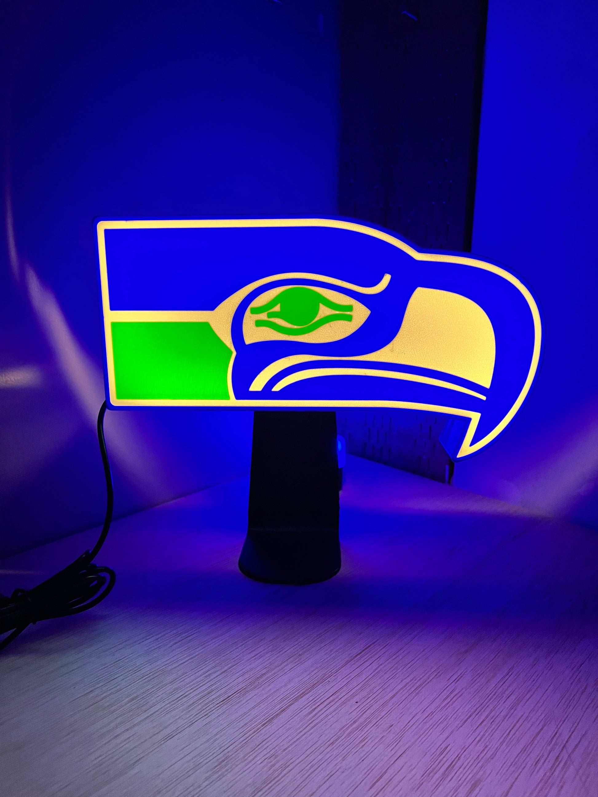 a close up of a blue wall with a green and yellow logo