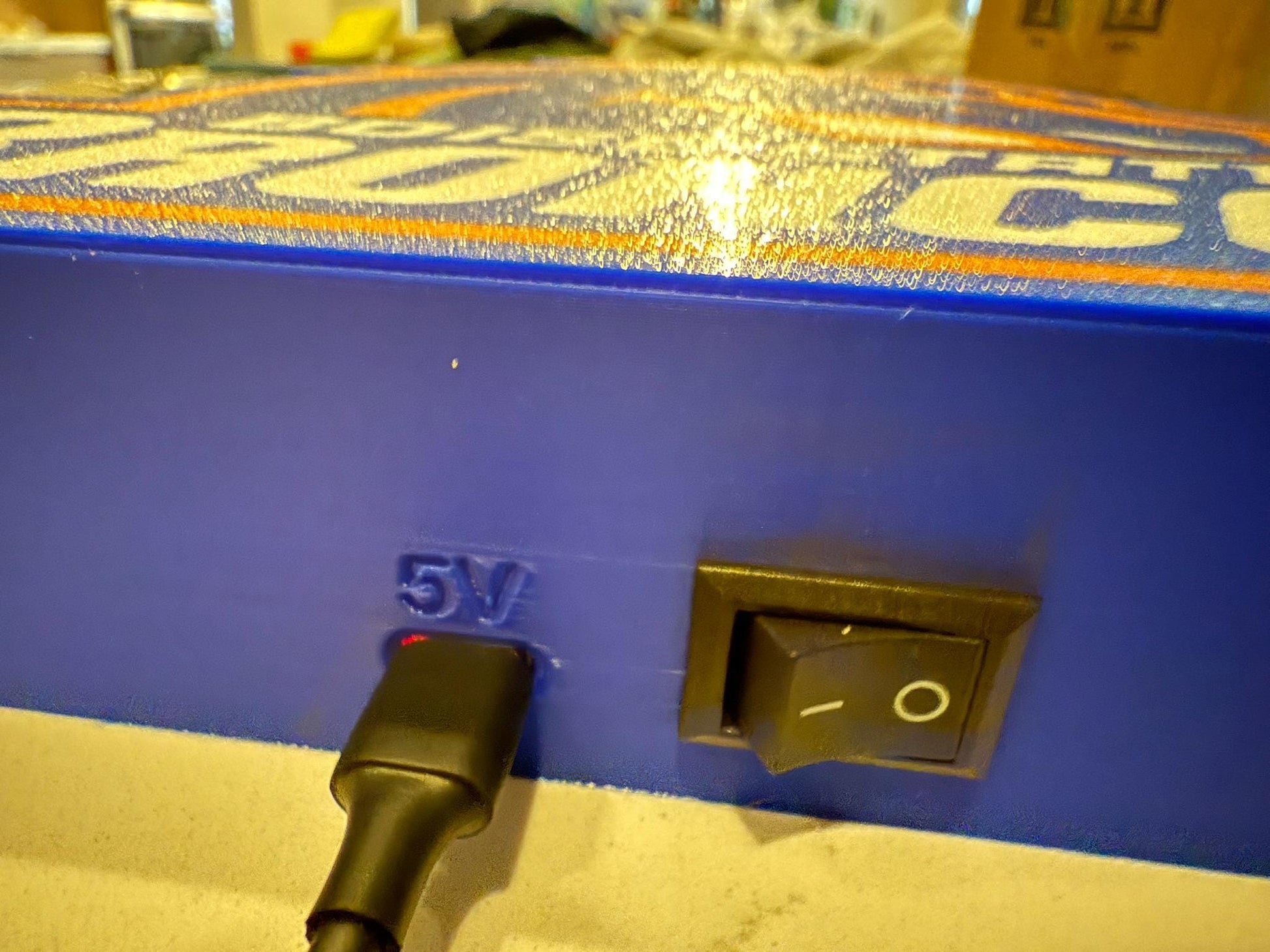a close up of a blue box with a black handle