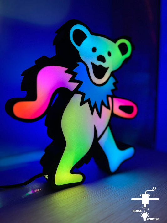 a paper cut out of a bear holding a pair of scissors