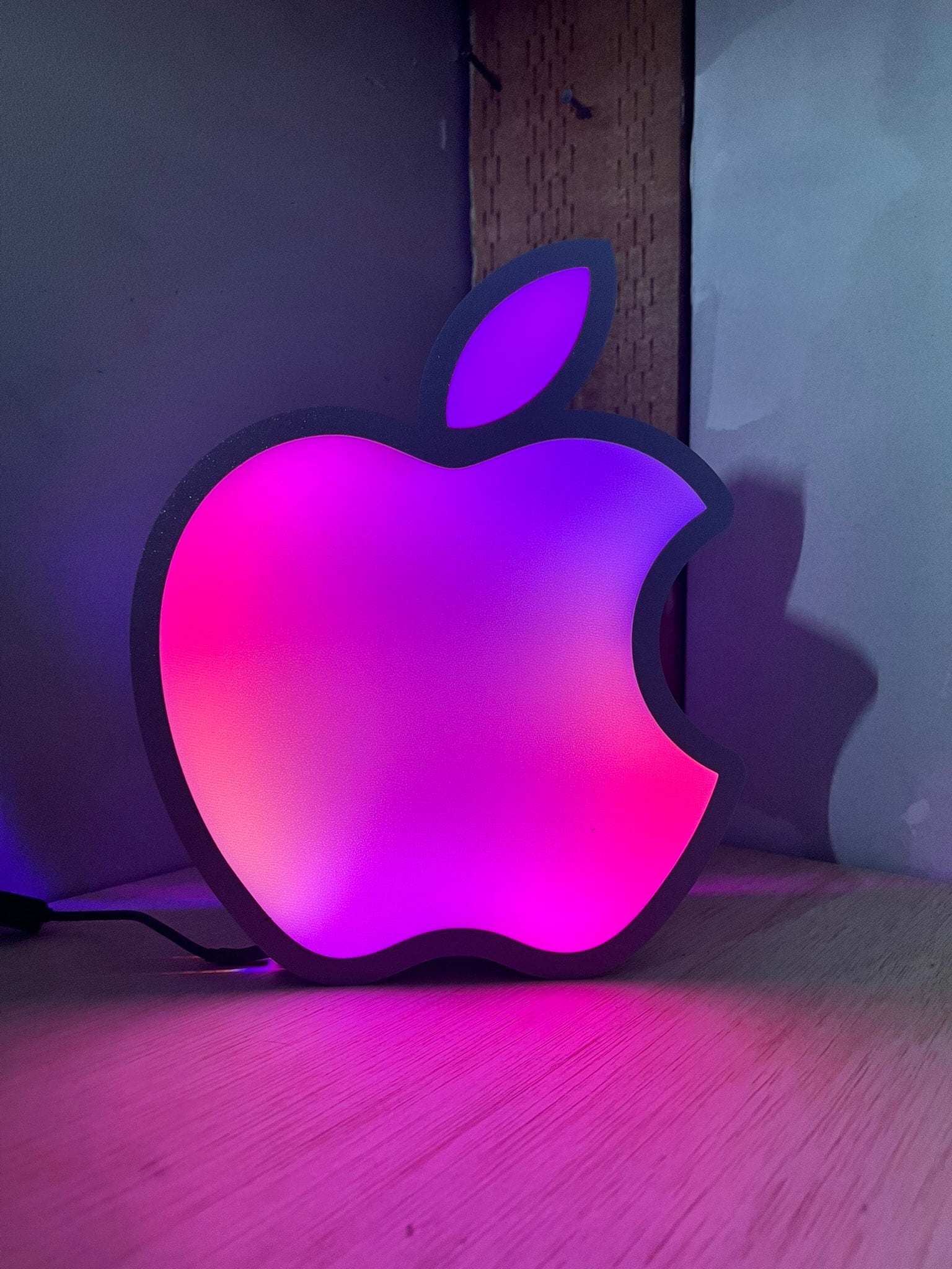 an apple logo sitting on top of a wooden table