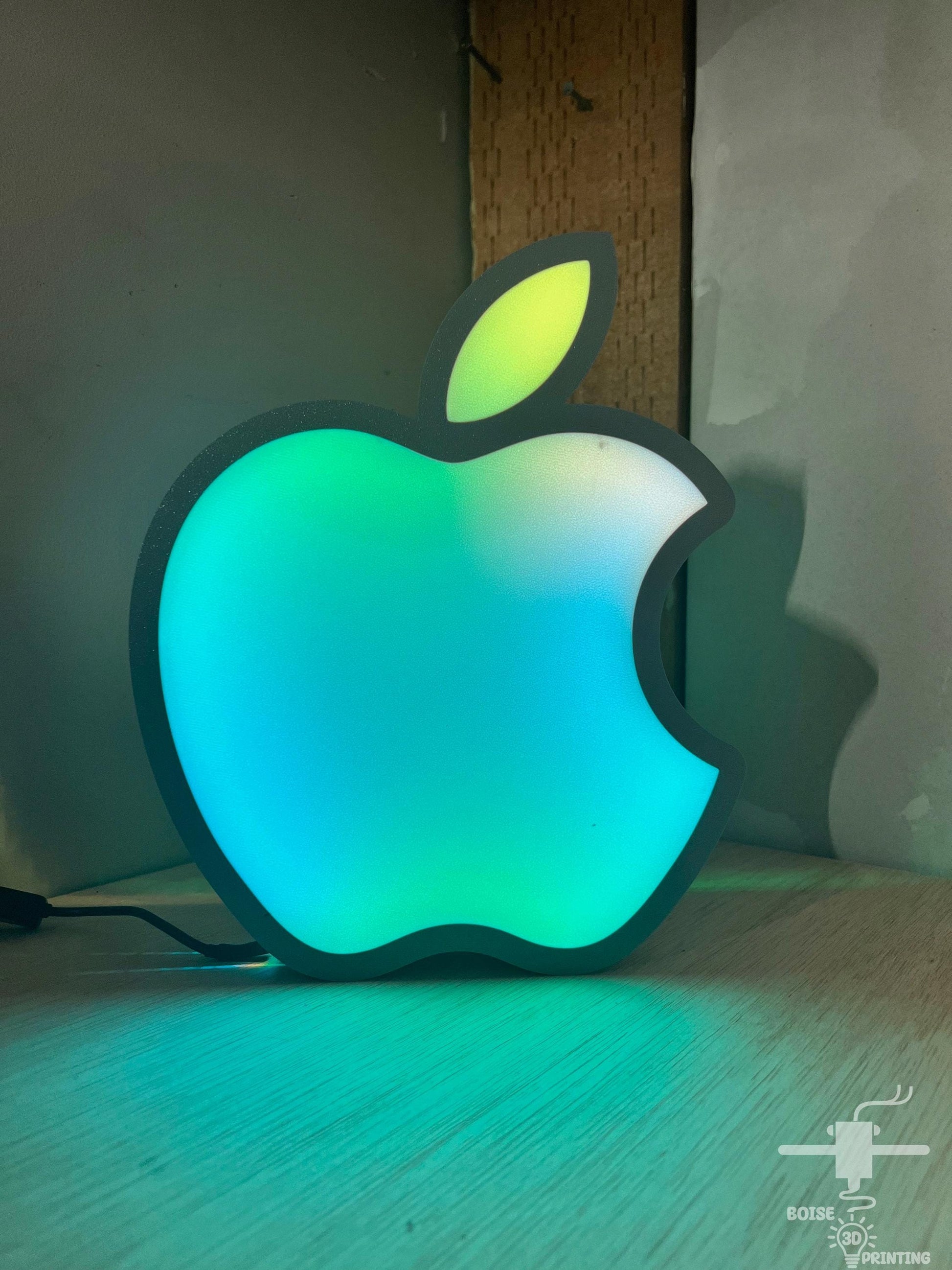 a glowing apple shaped object sitting on top of a wooden table