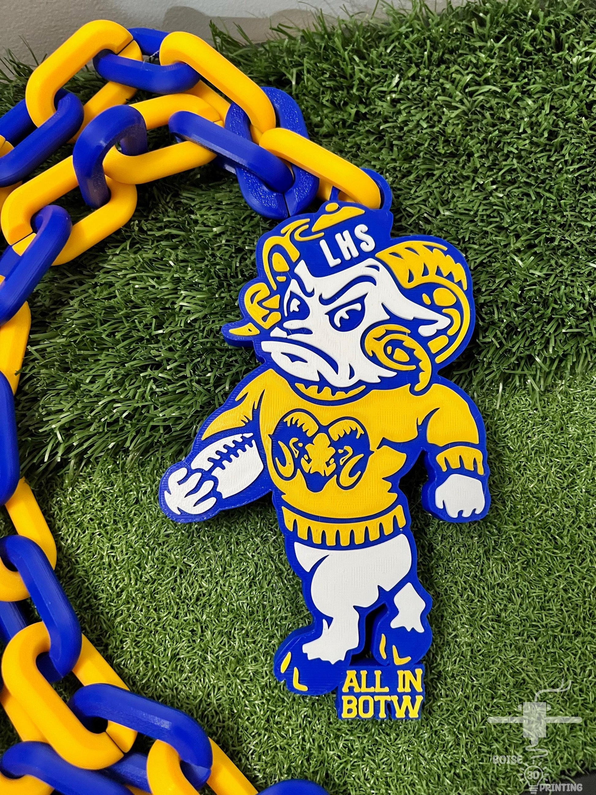 a blue and yellow chain with a yellow and white bear on it
