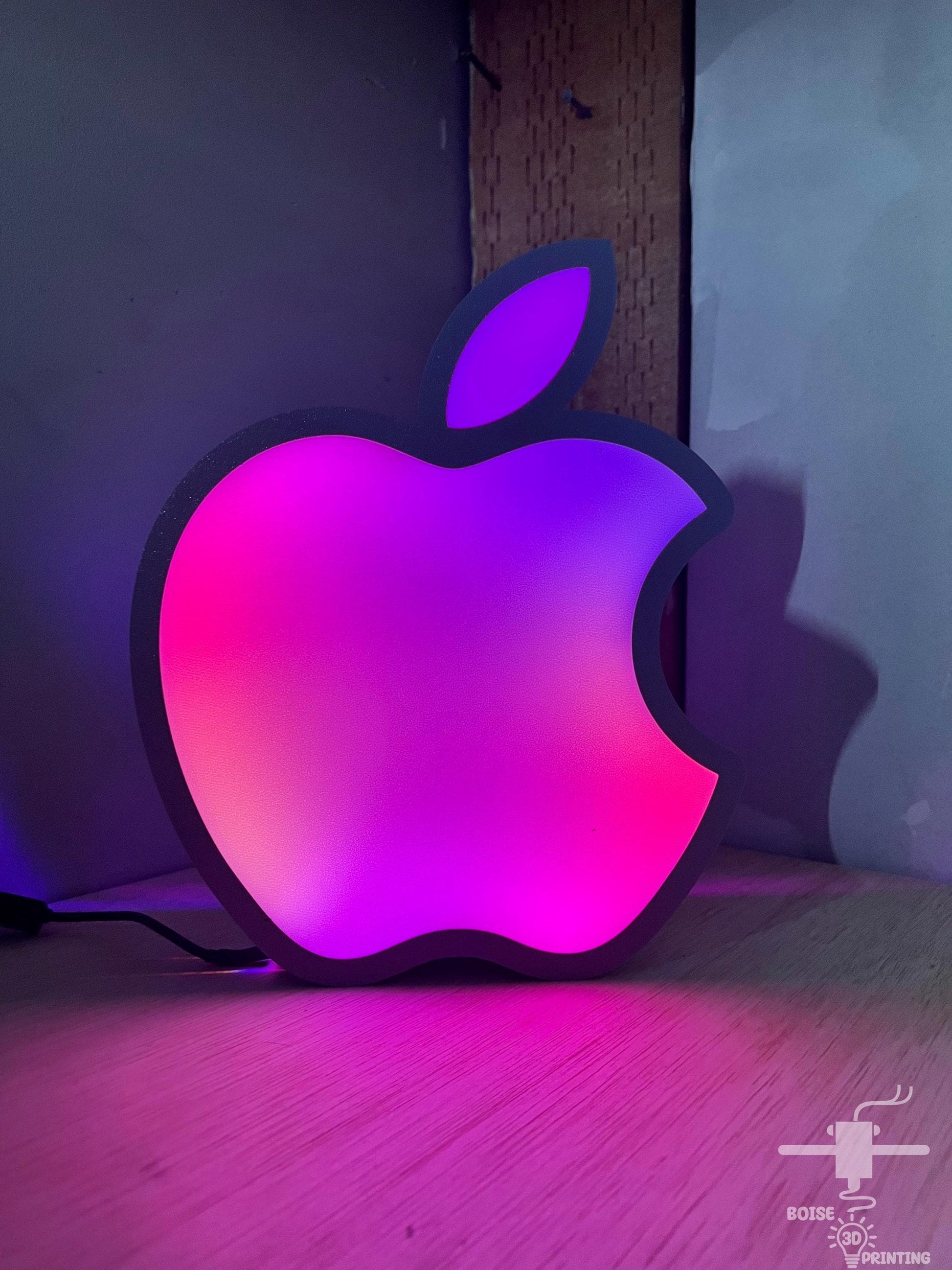 an apple logo sitting on top of a wooden table