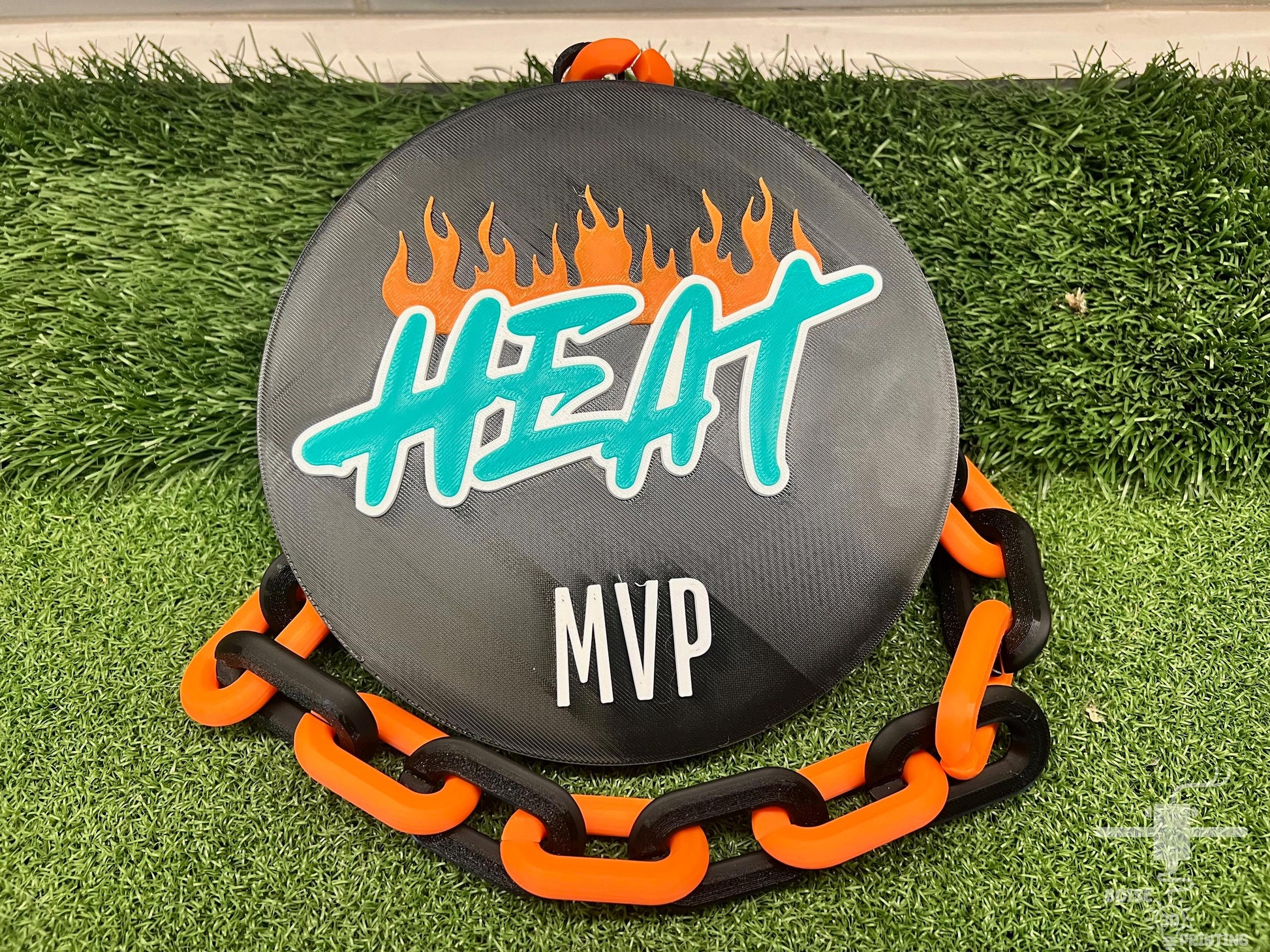a frisbee with a chain around it on the grass