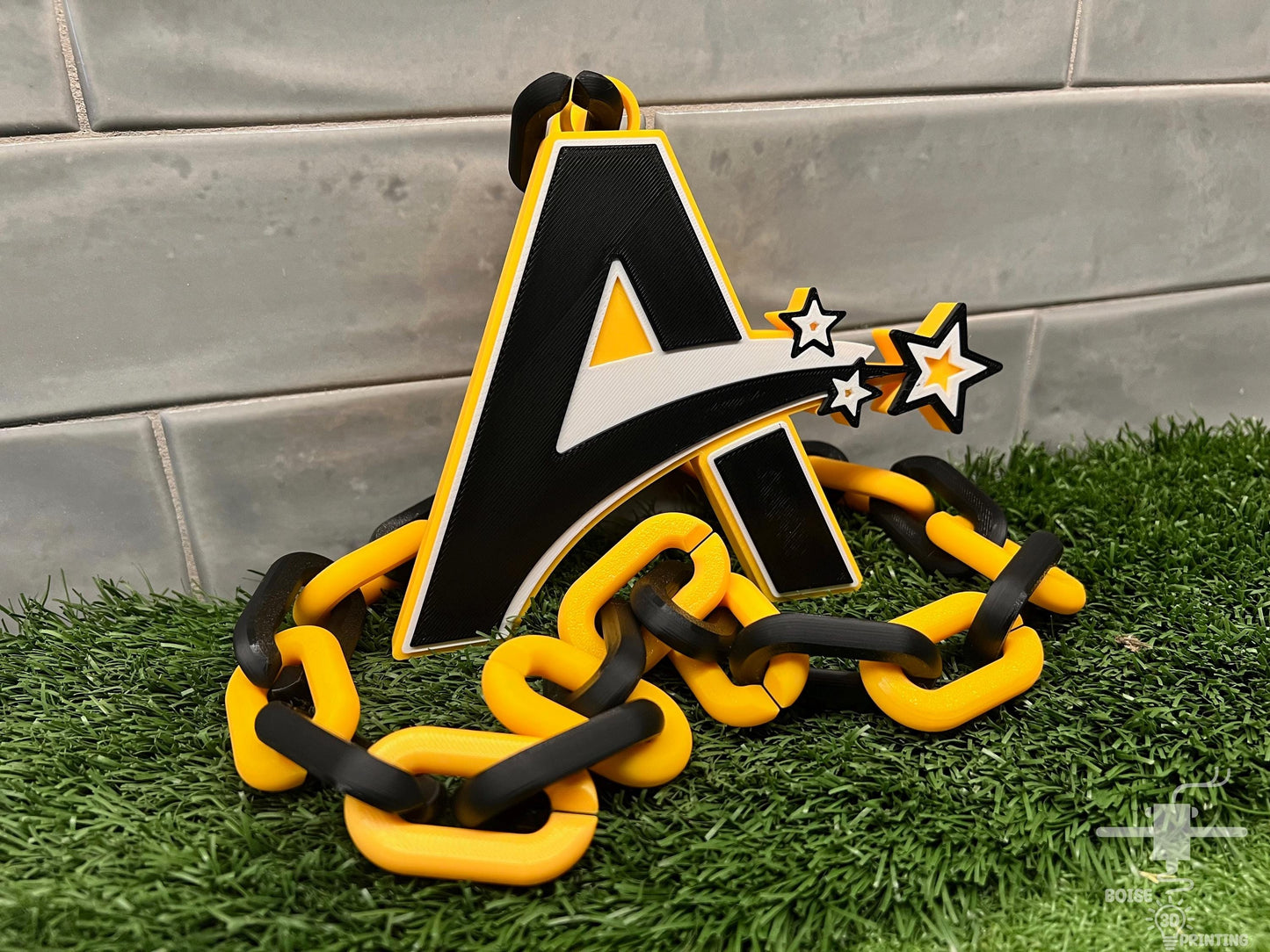 a black and yellow chain with a letter a on it