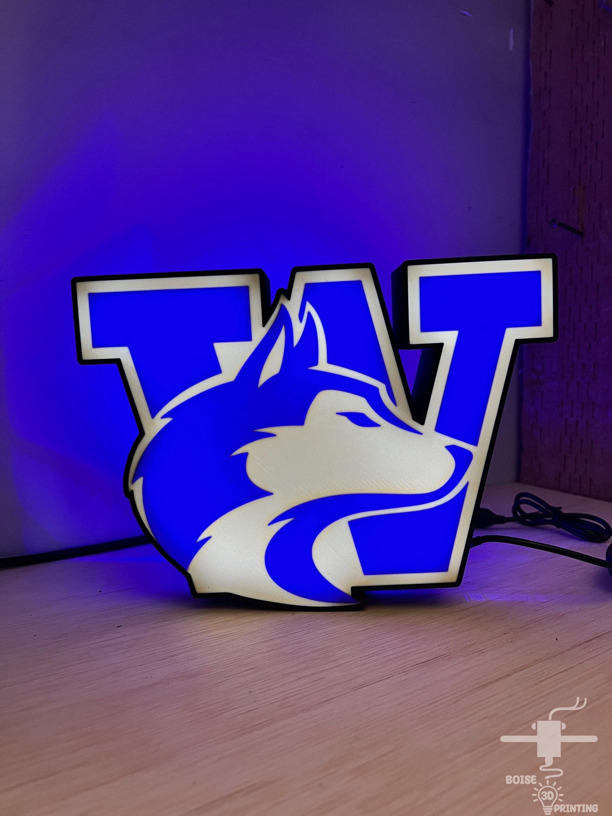a blue and white lamp with a logo on it