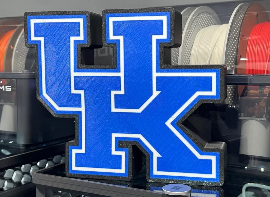a blue letter k on display in a store