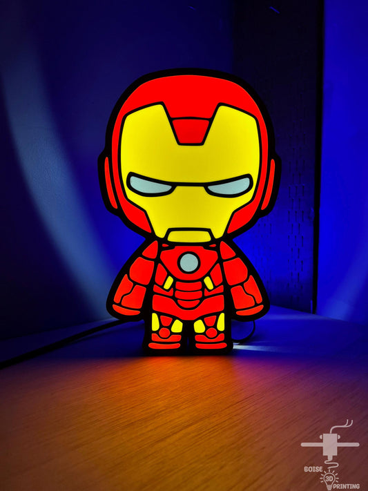 a paper cut out of iron man on a wooden floor