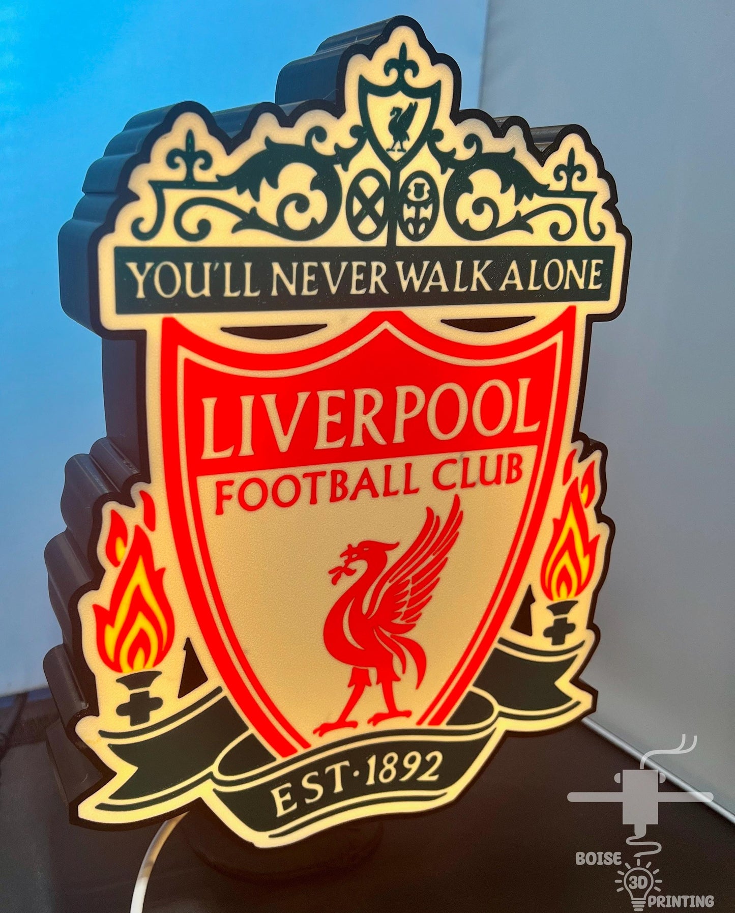 a liverpool football club neon sign on a table